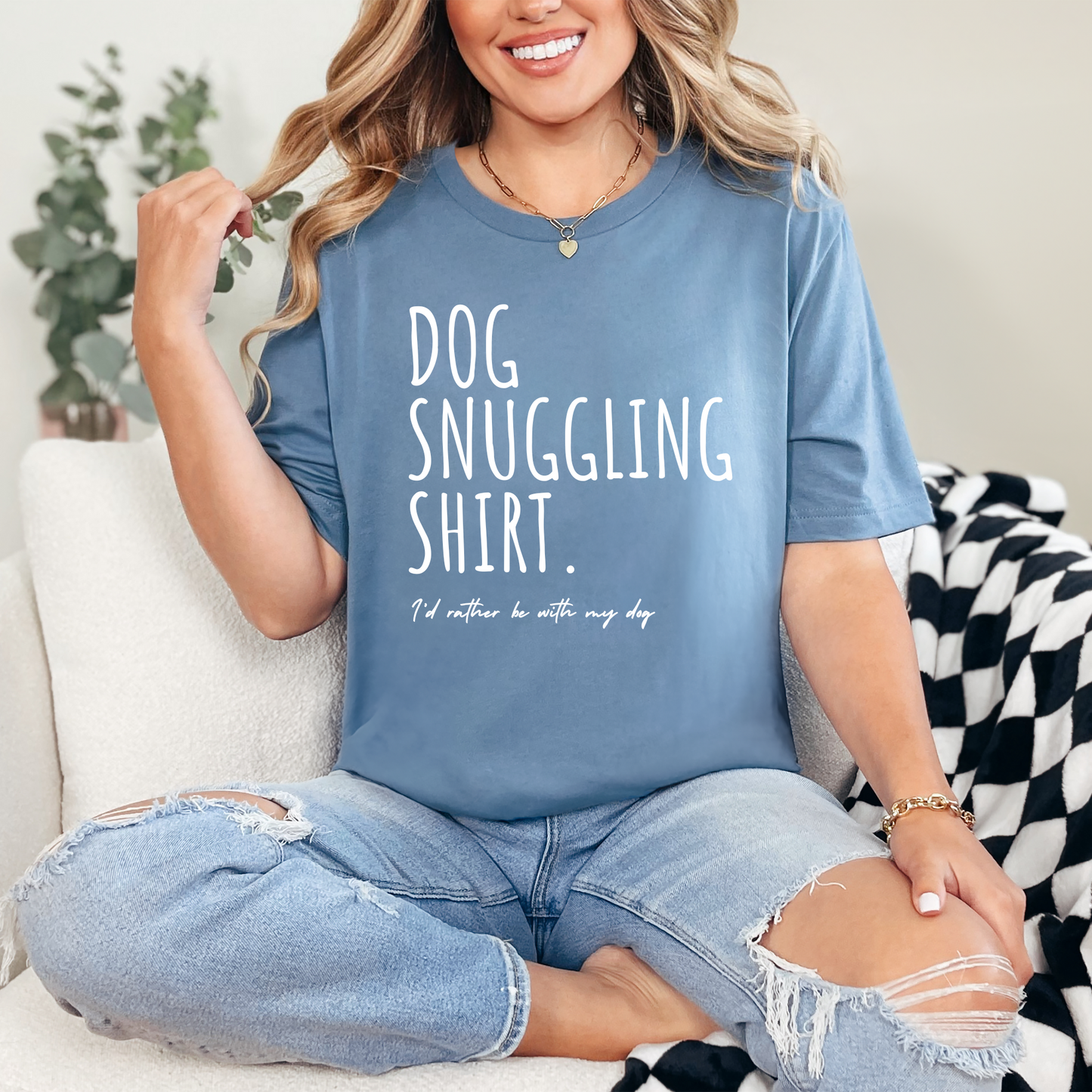Person wearing a blue graphic t-shirt that has "Dog Snuggling shirt" on it