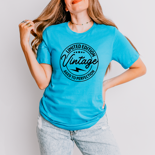 Person wearing a blue graphic t-shirt with a vintage logo.